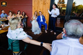 A joyful couple and their guests react with laughter and tears to heartfelt toasts during a wedding celebration at Nonesuch River Brewing in Scarborough, Maine.